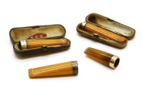 Lot 215 - Four gold and silver mounted amber cheroot and cigar holders