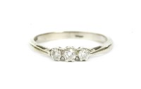 Lot 62 - A 9ct white gold three stone brilliant cut diamond ring