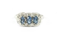 Lot 22 - A 9ct white gold three stone blue topaz and diamond cluster ring