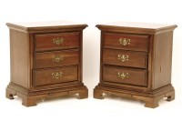 Lot 521 - A pair of modern mahogany three drawer bedside cabinets