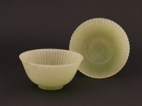 Lot 1204 - A pair of Chinese pale celadon jade chrysanthemum 'Lindsay' bowls