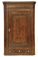 Lot 653 - A Georgian oak hanging corner cupboard