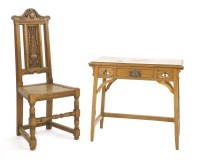 Lot 571 - An Arts and Crafts oak writing table