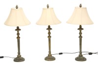 Lot 268A - A set of three gilded column form table lamps and shades