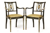 Lot 503 - A pair of ebonised and parcel gilt Regency design elbow chairs