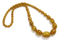 Lot 40 - A single row graduated toffee coloured olive shaped Bakelite bead necklace