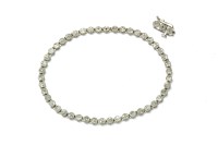 Lot 36 - A white gold diamond cluster line bracelet