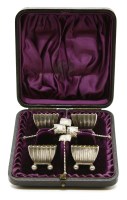 Lot 188 - A set of four Victorian silver table salts and spoons in the Japanese taste