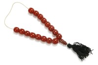 Lot 39 - A partial single row uniformed cherry coloured Bakelite prayer bead necklace