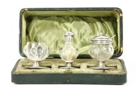 Lot 180 - An Arts & Crafts silver and blown glass cased cruet set