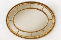 Lot 563 - An oval gilt wall mirror