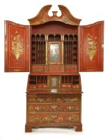 Lot 966 - A red lacquered bureau bookcase