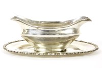 Lot 395 - An Egyptian silver sauce boat and stand of ovoid form