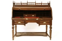 Lot 927 - A large Victorian walnut roll top desk