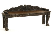 Lot 1000 - A Victorian carved oak bench with low raised back