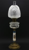 Lot 784 - A 19th century oil lamp with porcelain column