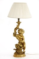 Lot 1120 - A gilded cherub lamp with wire shade support