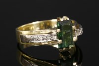 Lot 742 - An 18ct gold single stone tourmaline ring with diamond set shoulders.
A step cut tourmaline