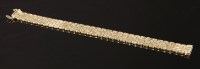 Lot 317 - A 9ct gold three row brick link bracelet