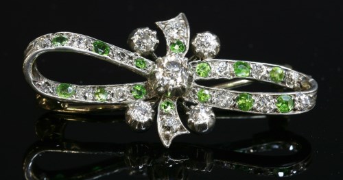 Lot 80 - A Victorian diamond and demantoid garnet bow brooch