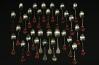 Lot 318 - A collection of approximately thirty silver golfing tea spoons