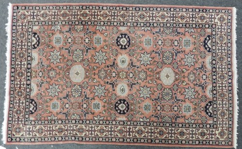 Lot 1094 - A pink ground caucasian rug