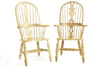 Lot 1019 - A pair of pine hoop backed elbow chairs