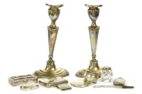Lot 405 - A pair of silver skinned candlesticks