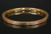 Lot 688 - A 9ct gold flat section slave hollow bangle