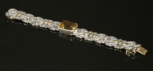 Lot 145 - A cased Arts & Crafts sterling silver and gold citrine bracelet