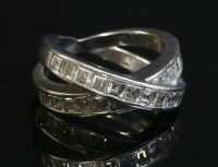 Lot 402 - A white gold two row diamond set crossover ring by Chopard