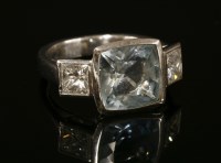 Lot 400 - A white gold three stone aquamarine and diamond ring by Chaumet