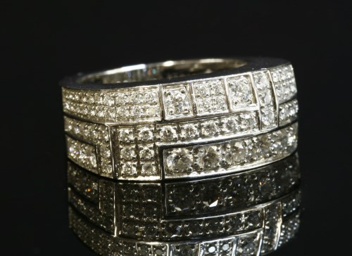 Lot 401 - A white gold diamond set band ring by Mauboussin