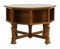 Lot 1212 - A Victorian octagonal oak and leather top library table 
raised on turned and carved supports