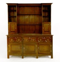 Lot 1066 - An oak dresser with shelves flanked with cupboards