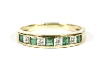 Lot 239 - A 9ct gold emerald and diamond half eternity ring