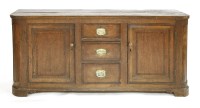 Lot 1172 - An oak dresser base with three central drawers