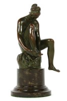 Lot 434 - A small bronze figure a lady rubbing her foot