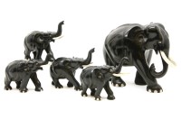 Lot 533 - Five ebony elephants with ivory tusks and toes