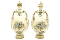 Lot 529 - A pair of Ernst Wahliss twin handled porcelain vases with lids