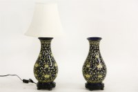 Lot 560 - A pair of oriental blue and yellow porcelain table lamps