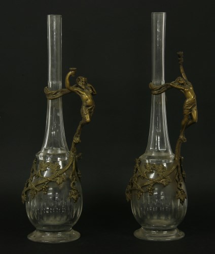 Lot 318 - A pair of cast metal and cut glass wine ewers