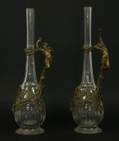Lot 318 - A pair of cast metal and cut glass wine ewers