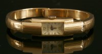Lot 212 - A ladies' 18ct gold Record Genève mechanical bangle watch