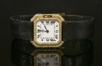 Lot 304 - A ladies' 18ct gold diamond set Cartier mechanical strap watch