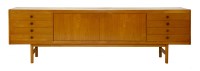 Lot 509 - A teak long sideboard