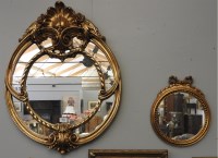 Lot 969 - An ornate gilt framed oval mirror
