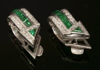 Lot 163 - A pair of Art Deco platinum emerald and diamond earrings of cuff form