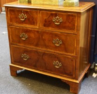 Lot 623 - A George III style inlaid walnut chest of drawers