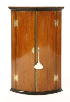 Lot 1050 - A George III satinwood bow front hanging corner cabinet